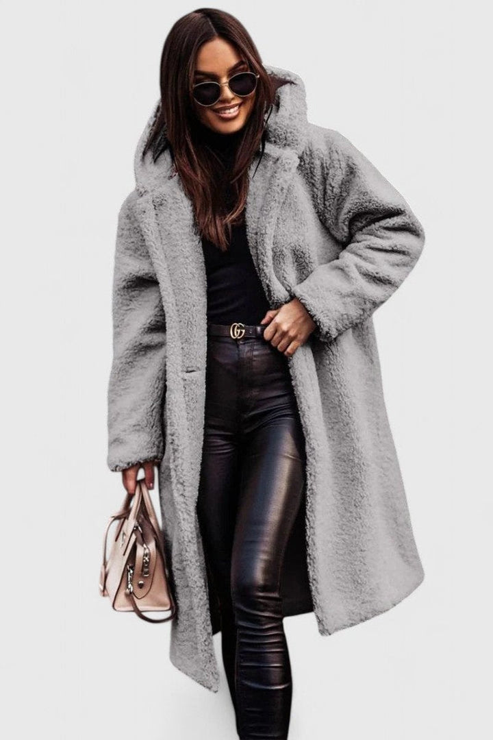 Light gray long hooded winter coat with fuzzy texture, open front and front pockets.