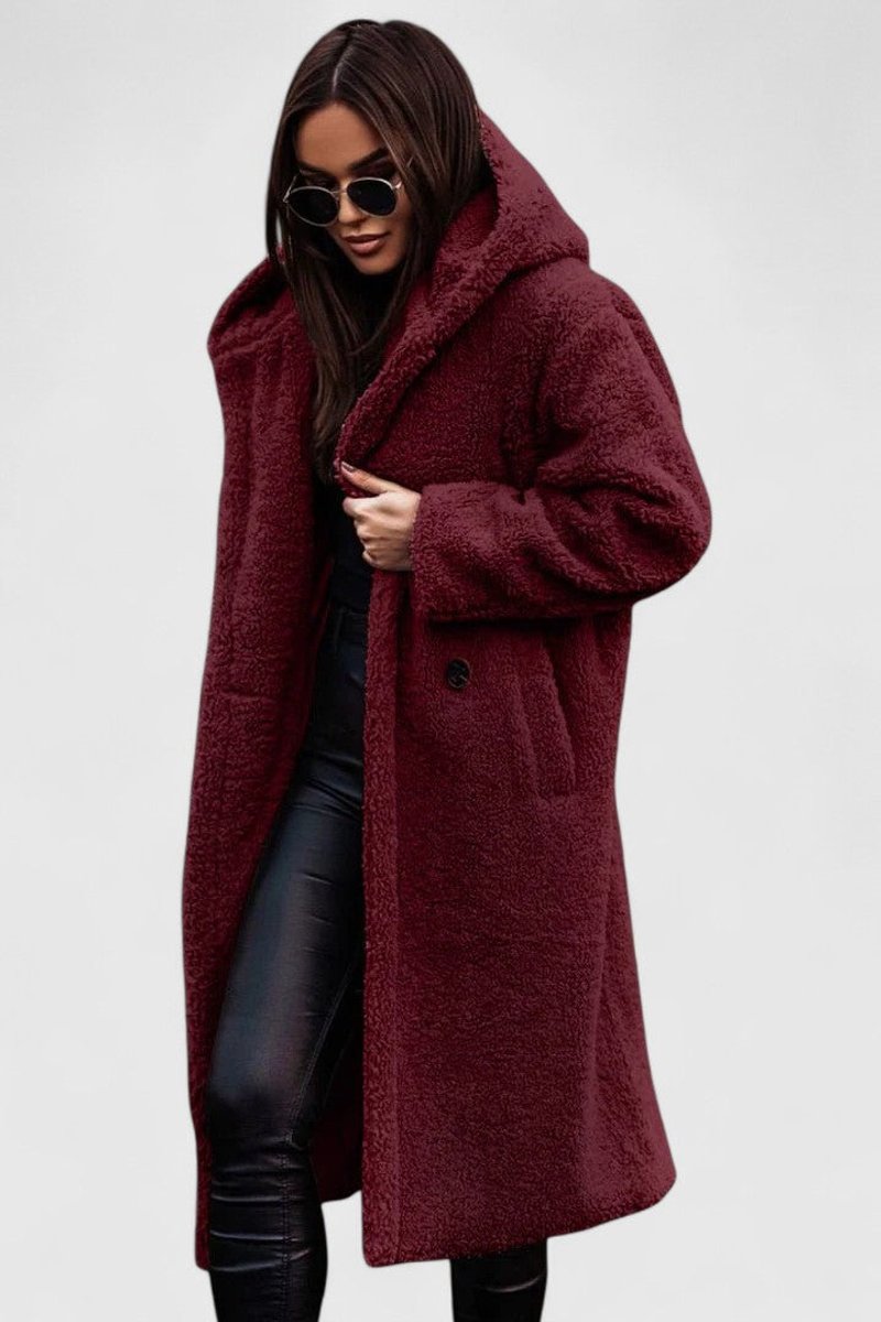 Burgundy long hooded winter coat with fuzzy texture, button front and front pockets.
