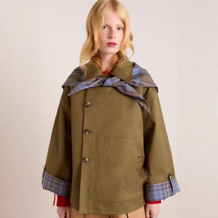 Oversized short jacket in olive-brown with double-button front, plaid cuffs, and cape collar