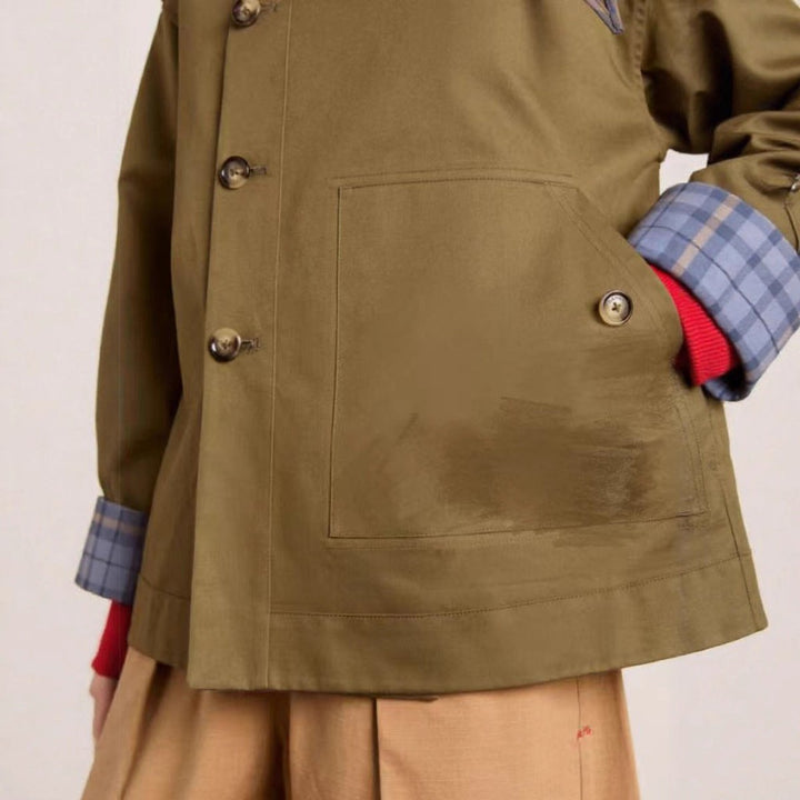 Oversized short jacket detail: olive-brown canvas, double buttons, and front pockets