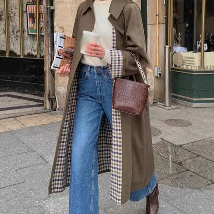 Oversized khaki trench coat with plaid-lined front opening and long draped length
