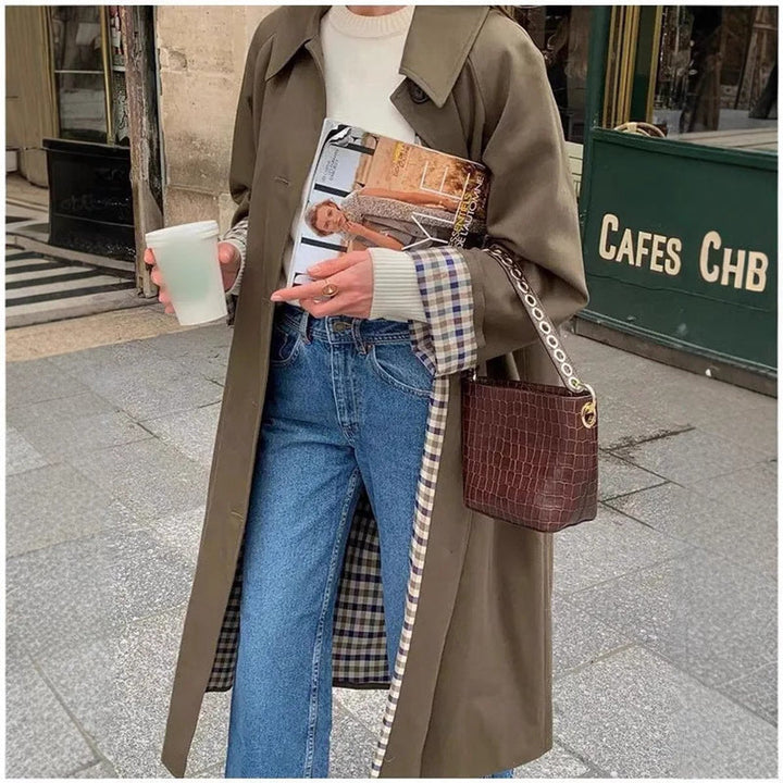 Oversized khaki trench coat with belted waist, wide lapels, and plaid-trimmed front