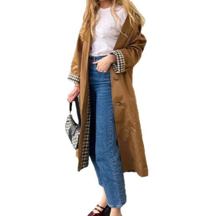Oversized khaki trench coat with lapel collar, button front, and long length