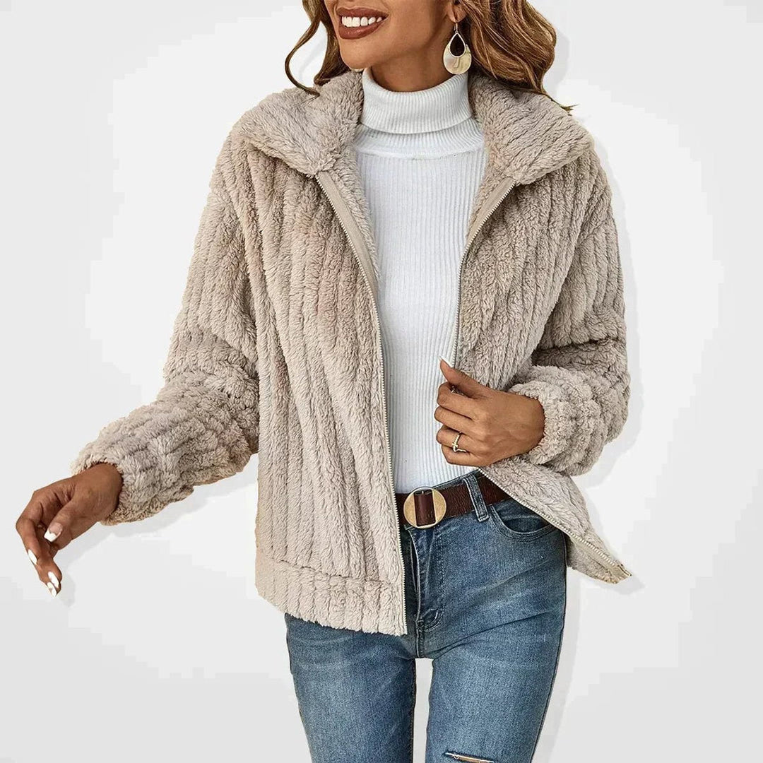 Front view: women’s beige textured zip-up jacket with stand collar and zip.