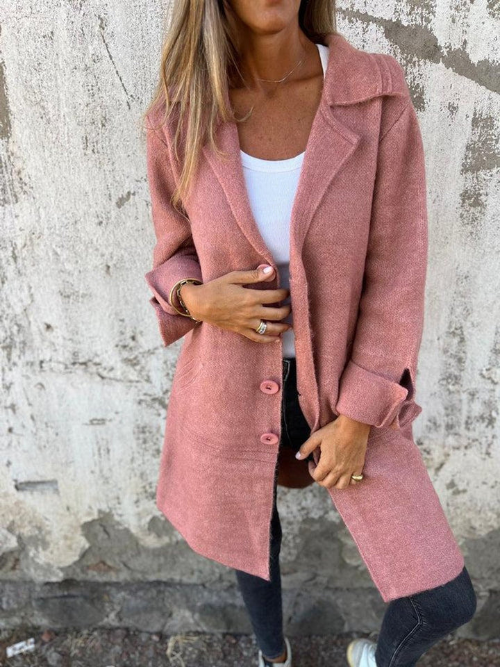 Rose pink long coat with lapel collar and button front, long sleeves, side pockets.