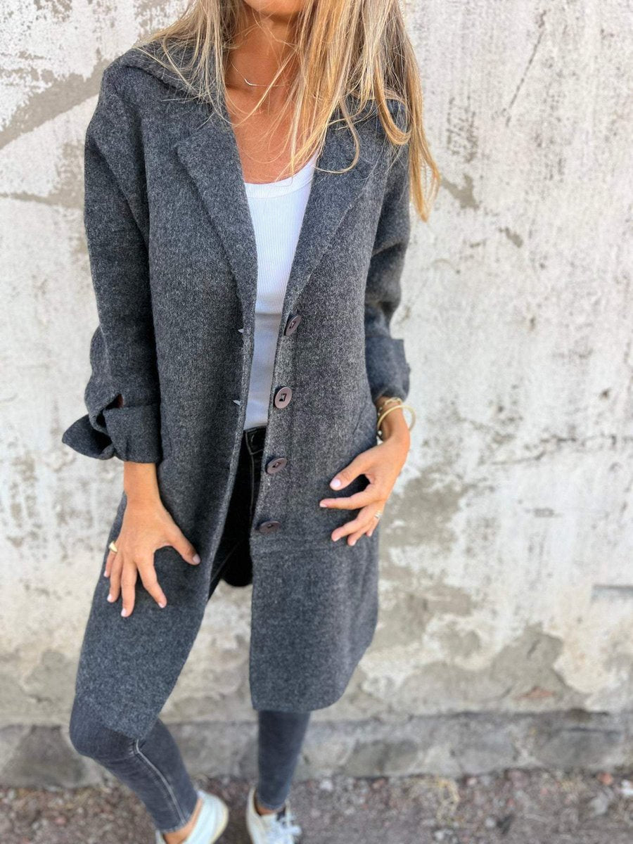 Dark gray long coat with notch lapel collar, button front, side pockets, long sleeves.