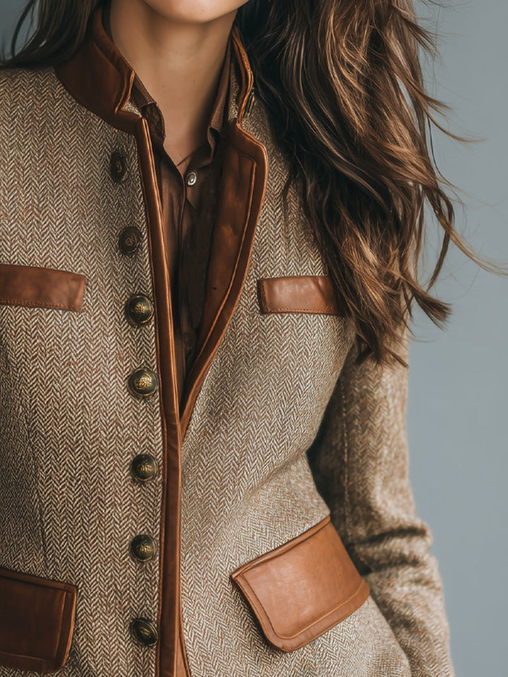 Brown herringbone blazer with leather trim, chest pocket, and two flap pockets